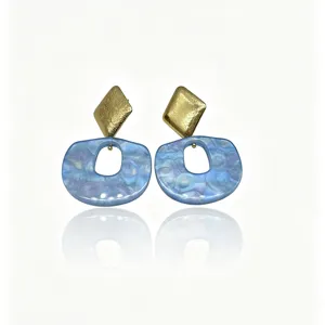Detailed close-up view of chic blue resin and gold geometric statement earrings for women.