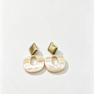 Detail shot of vintage geometric resin drop earrings with gold tone rhombus top.