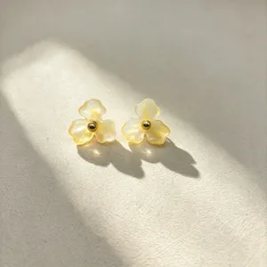 Chic yellow resin flower stud earrings with golden center bead, elegant floral design for women.