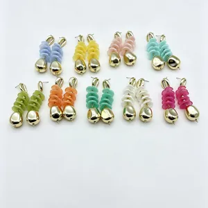 Colorful geometric beaded drop earrings with gold shell top and chic statement design.