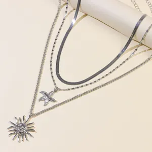 Multi-layer silver layered necklace with sun and starfish pendants, vintage fashion jewelry.