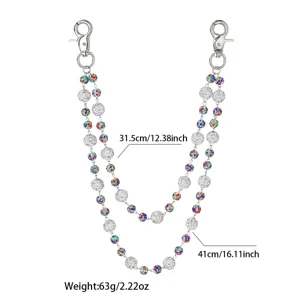 Detail view of double-layer rhinestone pants chain, silver metal with crystal balls and charms.