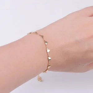 Gold heart chain anklet detail shot showcasing delicate alloy heart pendants and slim link design.