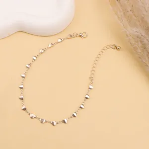 Detail shot of the gold-plated heart chain anklet showing delicate links and secure clasp.