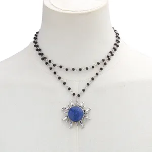 Double layer black beaded necklace with a stunning blue sun pendant, elegant jewelry accessory for women.