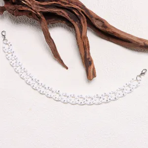 Detail view of a stylish white rhinestone hat chain with lobster clasps, elegant accessory.