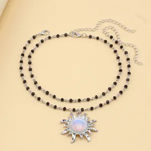 Double layer black beaded necklace with elegant sun pendant for women fashion jewelry style.