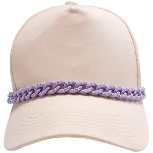 Pink baseball cap close-up, purple rhinestone chain detail, trendy fashion accessory.