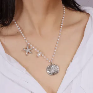 Close-up detail of ocean series pearl necklace featuring shell and starfish metal pendants.