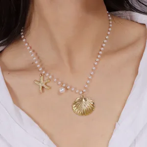 Close-up detail of the oceanic pearl necklace featuring golden starfish and seashell pendant.