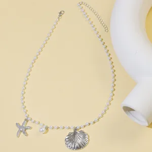 Ocean style pearl necklace featuring starfish and seashell pendants with extension chain.