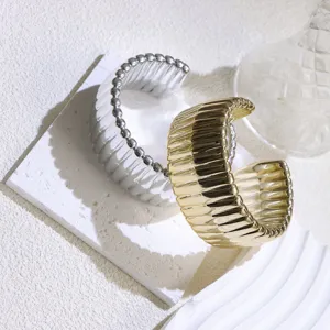 Chic wide open cuff bracelet set featuring textured metallic finish in gold and silver tones.