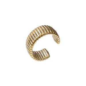 Gold wide ribbed open cuff bracelet detail, minimalist fashion statement hand jewelry for women.