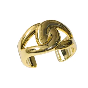 Wide gold open cuff bracelet with geometric knot design, chic minimalist women jewelry.