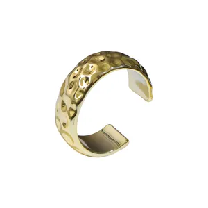 Gold wide hammered cuff bracelet for women, minimalist open bangle fashion jewelry accessory.