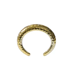 Chunky gold open cuff bracelet with hammered texture, minimalist wide bangle jewelry for women.