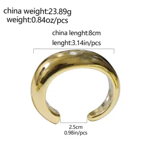 Detail view of wide gold open cuff bracelet, minimalist geometric design, stylish accessory.