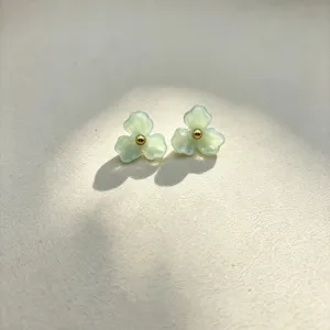 Chic resin three-petal flower stud earrings with a gold center bead, sweet minimalist jewelry.