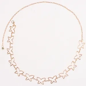Close-up detail of the gold metal hollow butterfly waist chain, elegant accessory for dress.