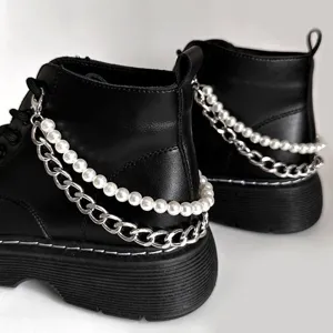 Black combat boots featuring stylish double-layer pearl and metal chain accessories.