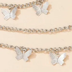 Silver multi-layer body chain detail featuring delicate metal butterfly charms for fashionwear.