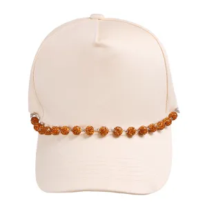 Beige baseball cap featuring a dazzling rhinestone crystal ball chain accessory detail.