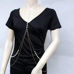 Detailed view of vintage faux pearl body chain, multi-layer gold metal jewelry for women.