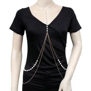 Body chain detail showing vintage gold metal links and multi-layer faux pearl arrangement.