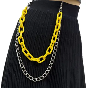 Close-up detail of double layer pants chain, yellow plastic and silver metal links, waist accessory.