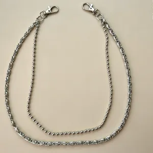 Close-up detail of the silver multi-layer metal pants chain with unique woven punk style links.