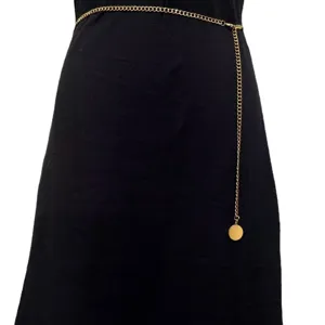 Gold metal waist chain detail showing the delicate single layer link and smooth round pendant.