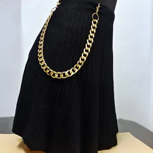 Punk style metal waist chain detail shot, featuring exaggerated thick gold chains.