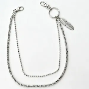 Detail shot of punk style multi-layer metal pants chain with feather pendant and lobster clasps.
