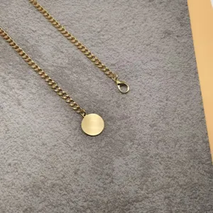 Gold metal waist chain for women, vintage single layer belly chain with smooth round pendant accessory.