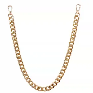 Detail shot of punk style chunky gold metal chain, featuring sturdy lobster clasps on both ends.