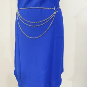 Closeup of multi-layer metal chain waist belt, silver body chain jewelry detail view.
