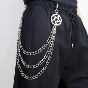 Detail shot of punk style multi-layer metal waist chain with pentagram charm on black trousers.