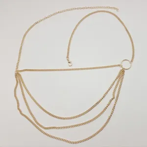 Detail shot of the multi-layer gold metal chain belt, showing fine links and circular ring.