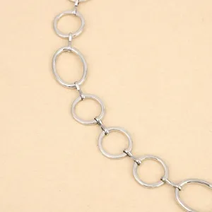 Punk metal waist chain detail close-up, silver tone round and oval links for women hip-hop.