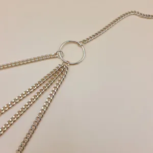 Detail shot of the multi-layer metal chain waist body chain with a center ring, vintage gold finish.