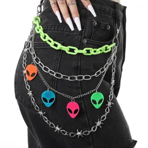 Close-up detail of punk multi-layer waist chain with neon green links and colorful alien pendants.