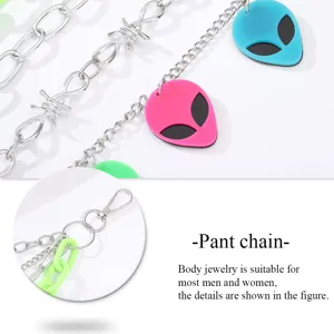 Detail shot of metal pant chain with colorful alien pendants and barbed wire links.