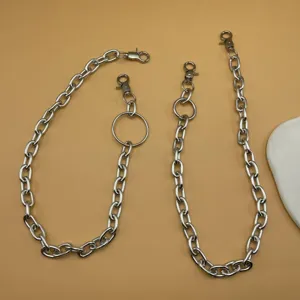 Silver metal chain detail showing links and clasps for trousers or waist accessories.