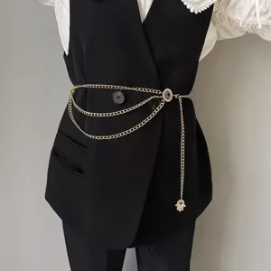 Exquisite gold layered waist chain featuring evil eye and hamsa hand pendants for chic styling.