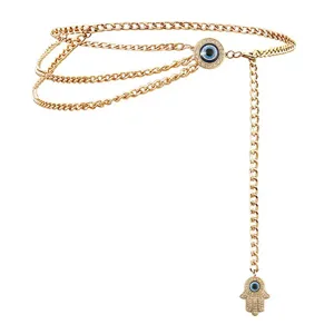 Gold multi-layer waist chain with evil eye and hamsa hand pendant for women fashion accessory.