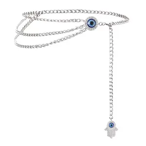 Silver multi-layer waist chain detailed view featuring evil eye and hamsa hand rhinestone pendants.