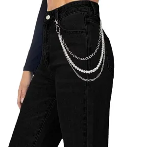 Detail view of the multi-layered pearl and metal waist chain, showcasing the hip-hop style.
