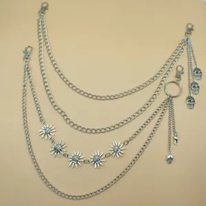 Detailed view of punk style multi-layer metal waist chain with skull and sun pendants.