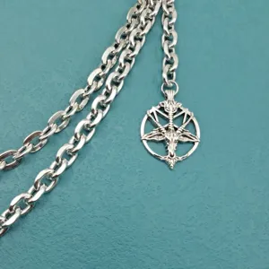 Punk metal waist chain close-up, silver chain with goat pentagram pendant, edgy streetwear.