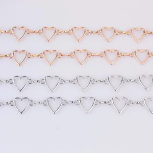 Close-up detail view of metallic hollow heart shape link chains in gold and silver finish.